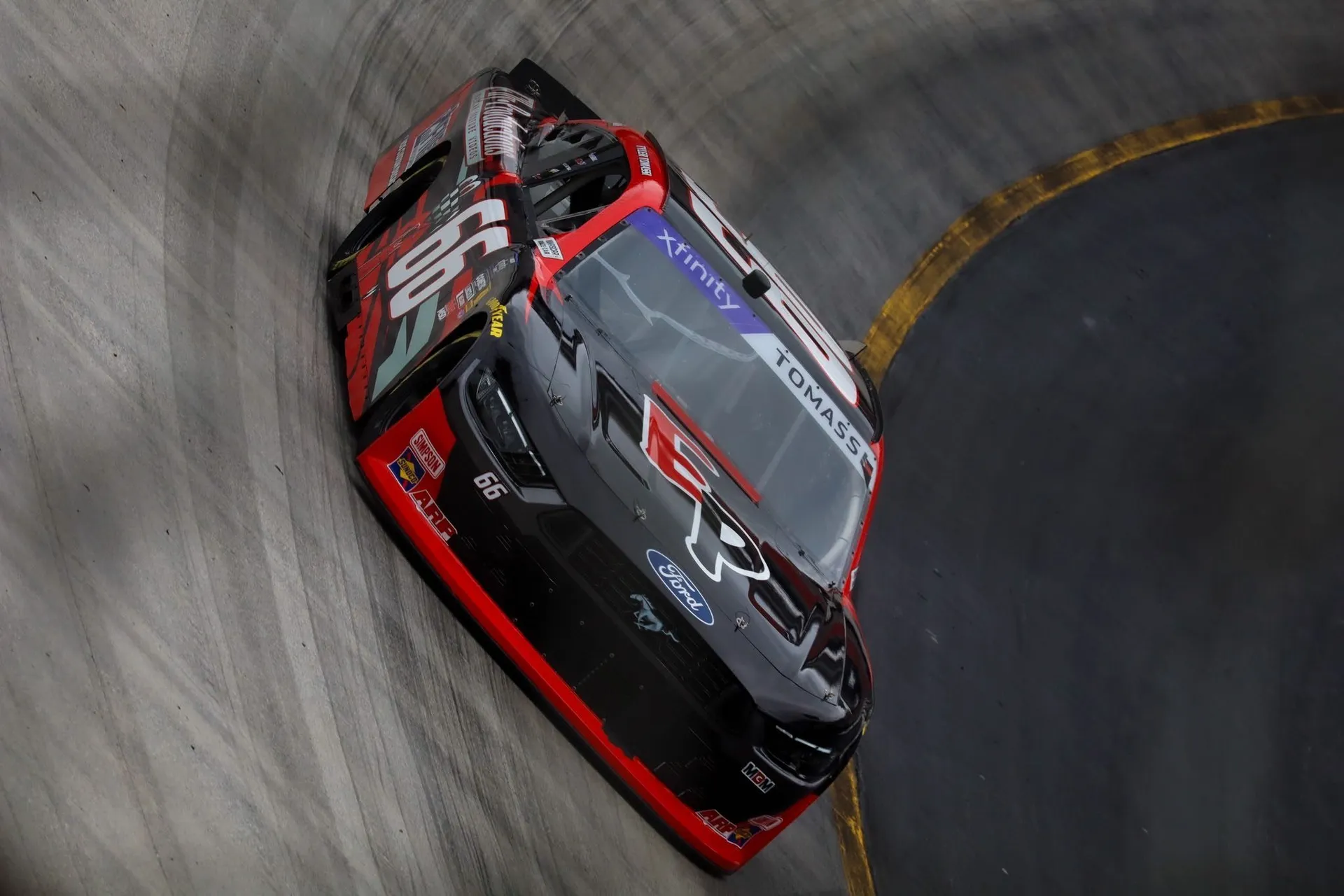 No. 66 Mustang leaning through a banked corner